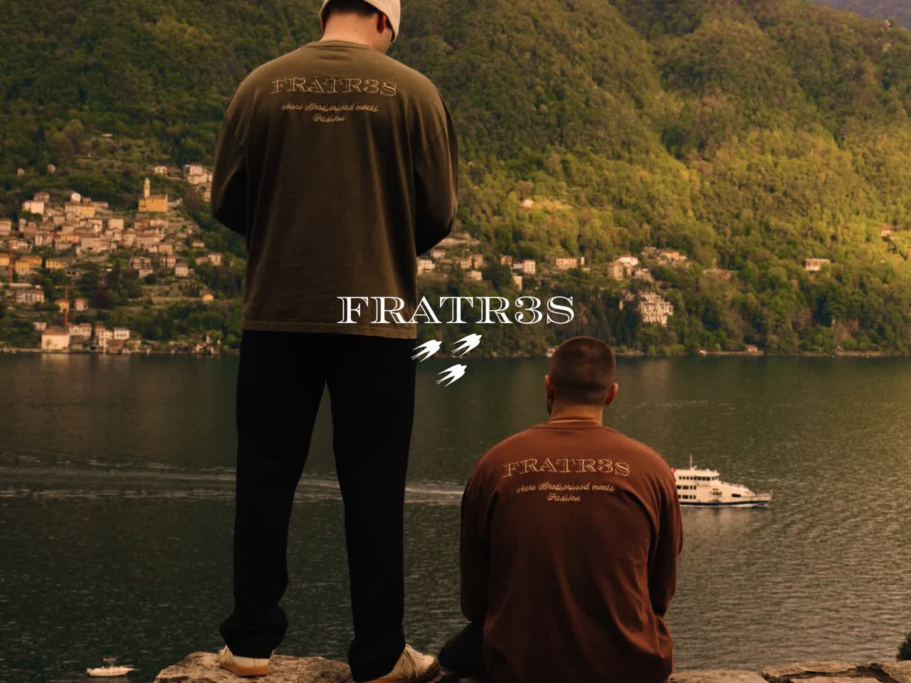 Two men in Fratr3s sweaters overlooking a lake