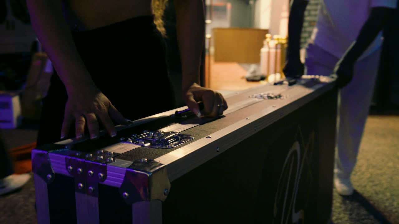 Hands setting up a mirror photo booth at an event