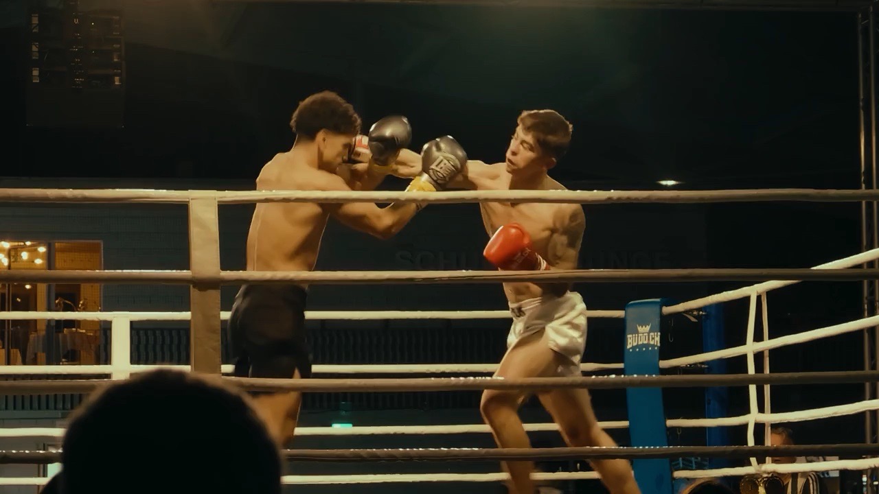 Two fighters exchanging punches in the ring